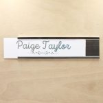 A name plate holder for doors and walls