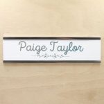 A name plate holder for doors and walls