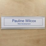 A name plate holder for doors and walls