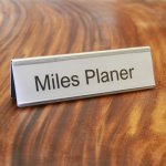 A name plate holder for desks