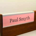A name plate holder for partitions