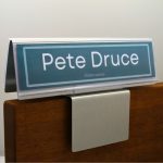 A name plate holder for partitions