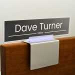 A name plate holder for partitions