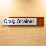 a name plate holder for doors and walls made from wood with a printed insert example